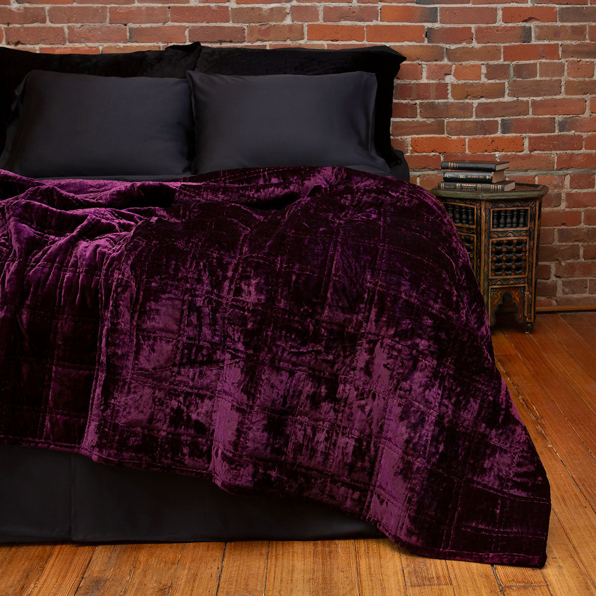 Amethyst purple velvet box quilt on a bed. Moody, witchy velvet bedding.