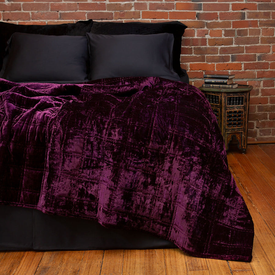 Amethyst purple velvet box quilt on a bed. Moody, witchy velvet bedding.
