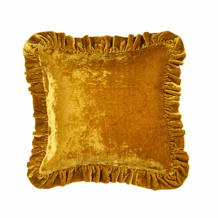 Gold velvet pillow with ruffled edges on a white background