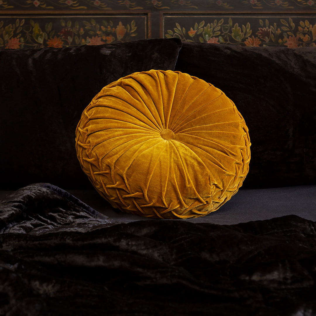 Gold velvet pintuck pillow on a bed of black velvet bedding. Luxurious throw pillows by Sin in Linen. 