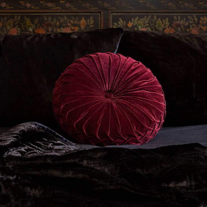 Ruby red velvet pintuck pillow on a bed of black velvet bedding. Luxurious throw pillows by Sin in Linen. 