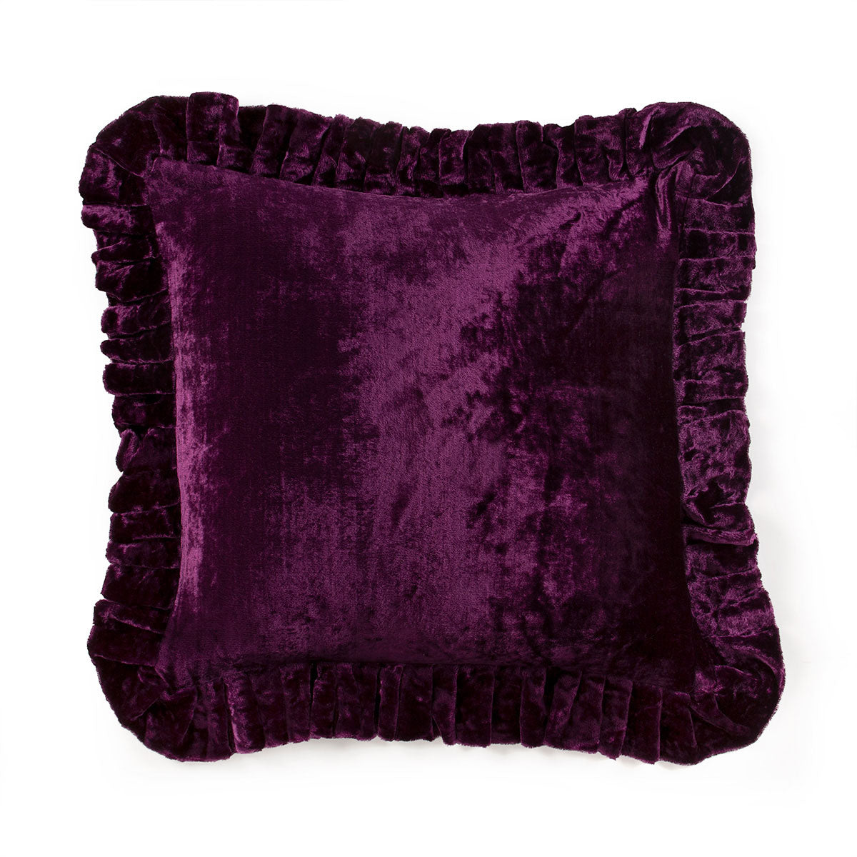 Purple velvet pillow with ruffled edges on a white background