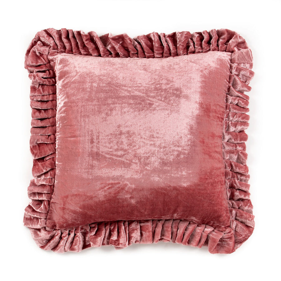 Pink velvet pillow with ruffled edges on a white background
