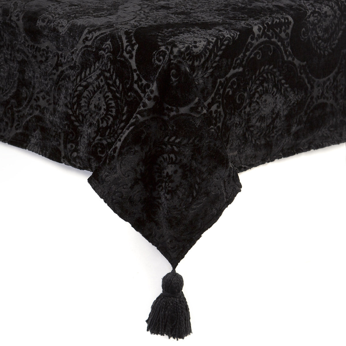 A velvet tablecloth with a damask design and tassel