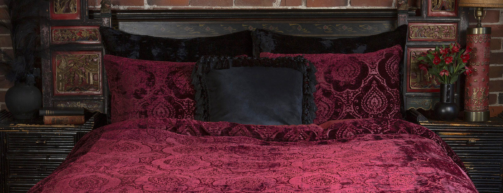 Burgundy velvet bedding with a damask pattern for gothic boudoirs. 