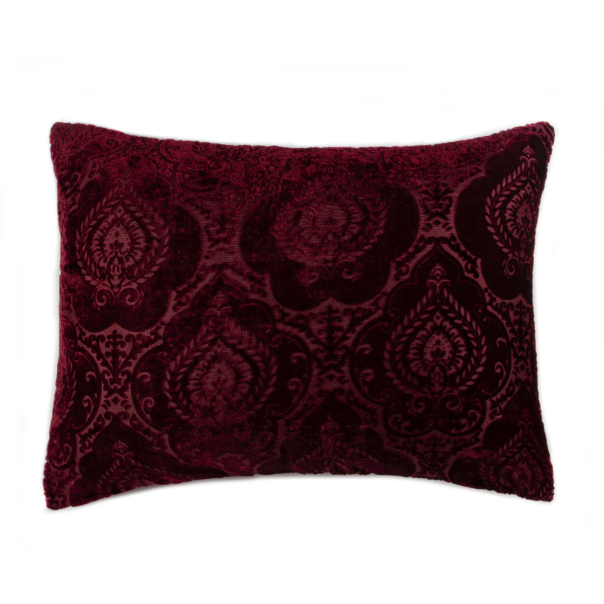 A deep ruby red velvet pillowcase with a damask pattern.