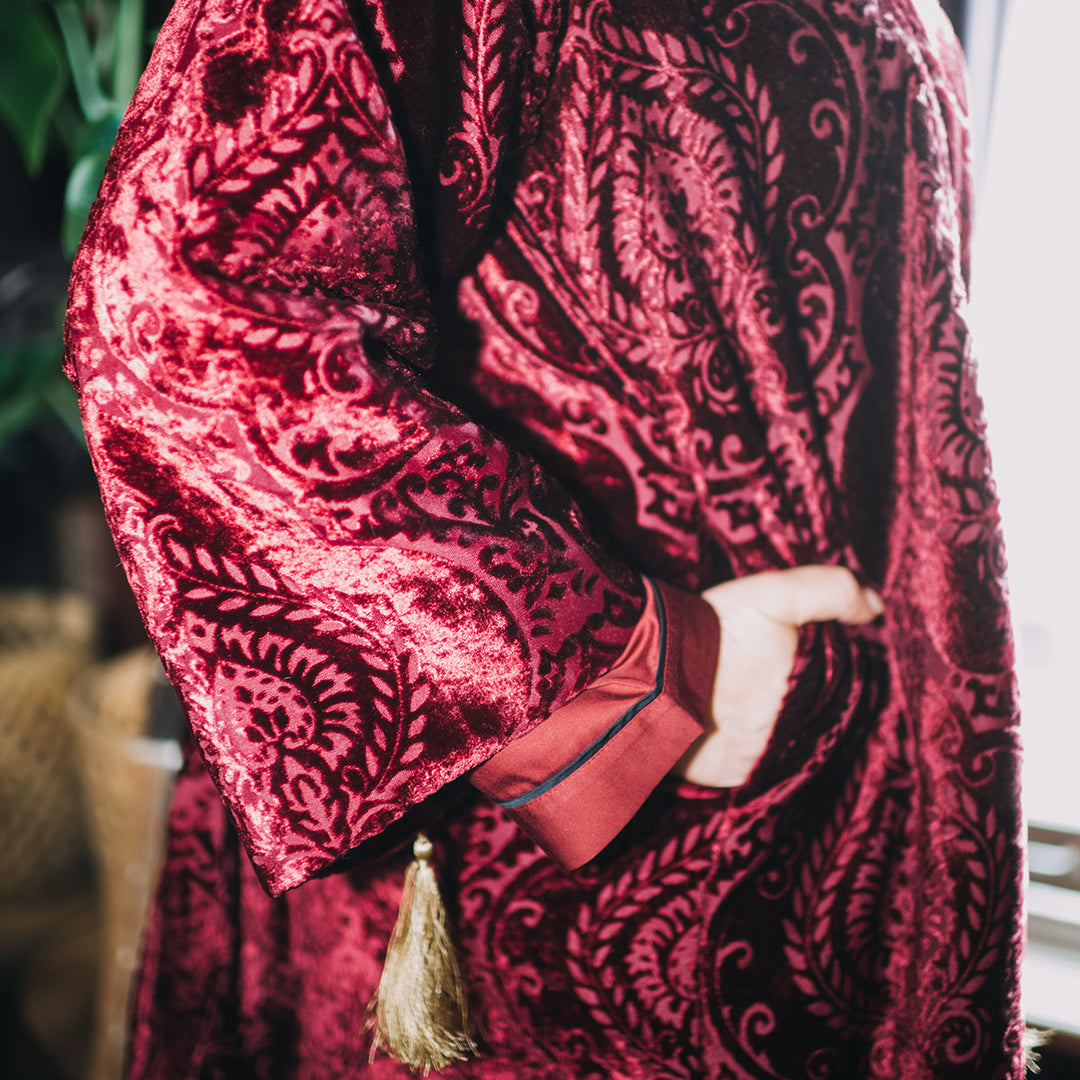 Close up of a ruby red velvet robe with a damask pattern. Luxury sleepwear from Sin in Linen. 