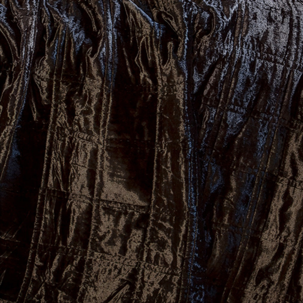 Swatch of quilted black velvet fabric