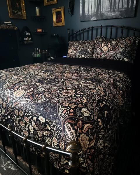 Black botanical bedding on a bed. Night Garden by Sin in Linen. 