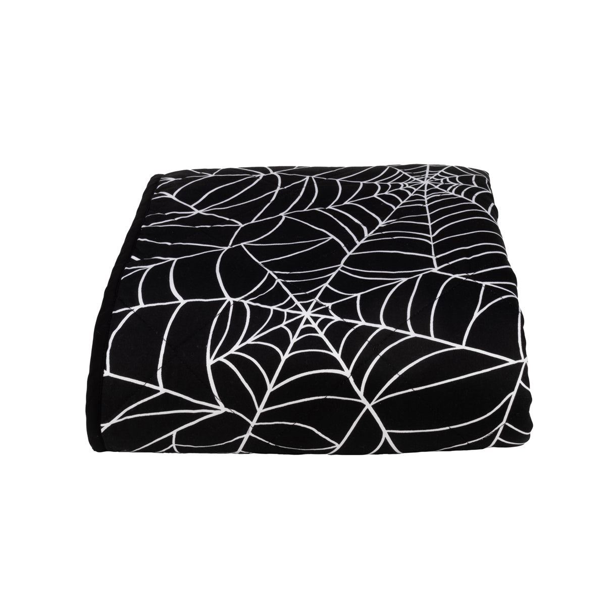 A folded black and white spider web throw blanket on a white background.